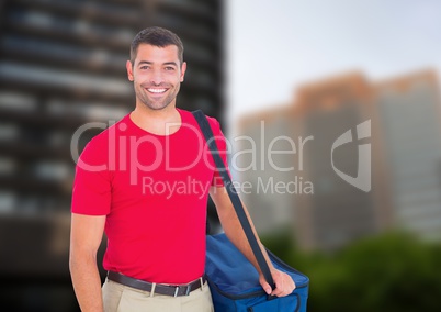 Happy pizza deliveryman with delivery bag in the city