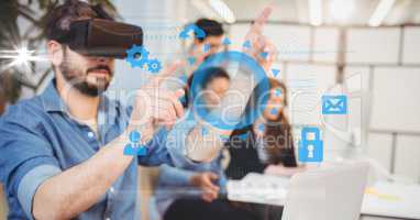 Digitally generated image of businessman touching icons while using VR glasses with colleagues in ba