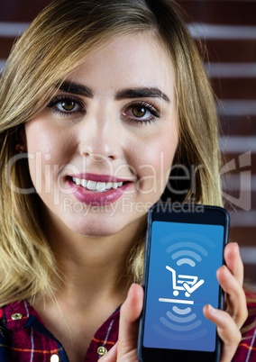 Woman holding phone with Shopping trolley icon