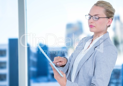 Woman working with the tablt in front of the window