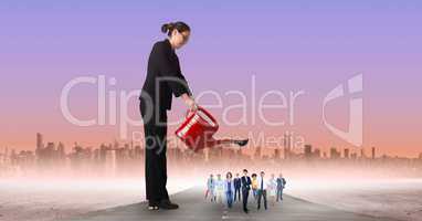 Businesswoman watering employees