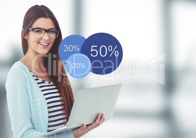Woman with laptop and blue statistics in blurry grey office