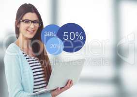 Woman with laptop and blue statistics in blurry grey office