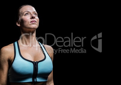 Female athlete looking up against black background