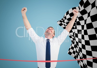 Business man at finish line against blue background and checkered flag
