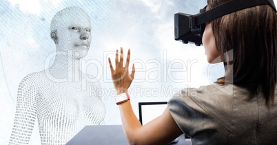 Woman in VR at desk in front of 3D female shaped binary code against sky and clouds