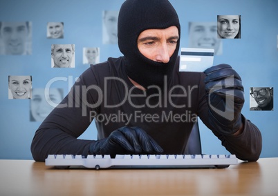 Criminal in hood on laptop with card in front of peoples profile faces