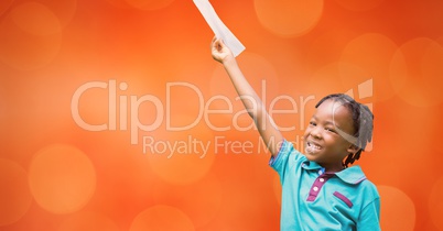 Happy girl holding document against orange background
