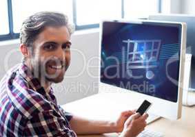 Man using laptop with Shopping trolley icon