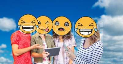 Digitally generated image of friends faces covered with emoji using digital tablet and smart phone a