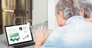 Senior business couple looking at graph and chart in laptop