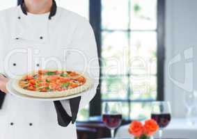 Chef with pizza with table with wine background