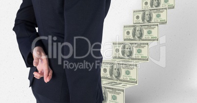 Midsection of business person crossing fingers with money in background