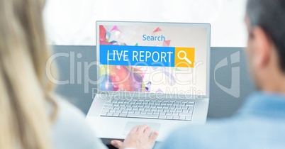 Rear view of man and woman searching for live report on laptop