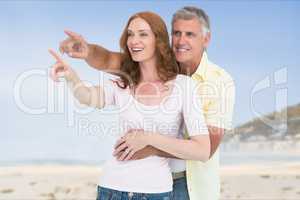 Affectionate couple gesturing while standing at beach