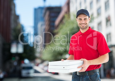 Happy deliveryman with pizza boxes in the city