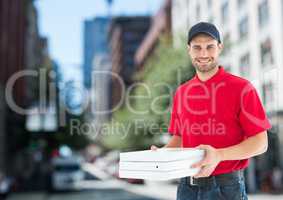 Happy deliveryman with pizza boxes in the city
