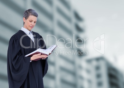 Judge holding book in front of buildings