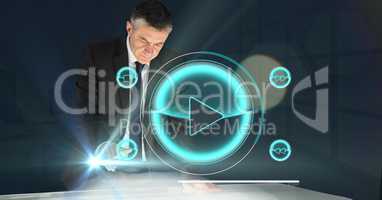 Digital composite image of businessman analyzing music icon on futuristic desk