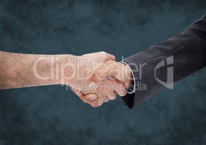 Handshake against dark blue grunge background