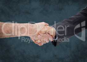 Handshake against dark blue grunge background