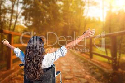 Rear view of carefree woman in wheel chair at park