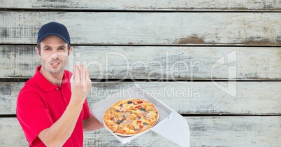 Delivery man gesturing while holding fresh pizza