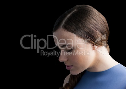 Woman with head down against black background