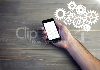 Hand with phone and white cog graphics with flare