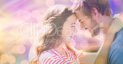Young couple touching heads over bokeh