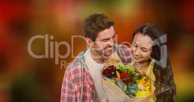 Couple with flower bouquet over blur background