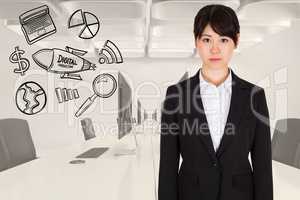 Digitally generated image of businesswoman standing by various icons in office
