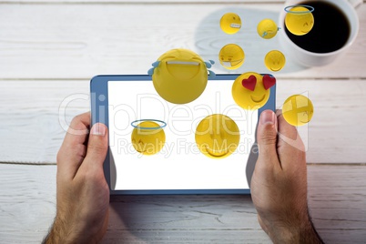 Composite image of tablet and smileys in 3d
