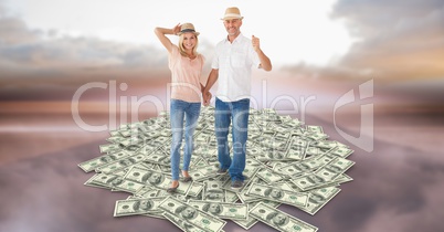 Couple holding hands while walking on money