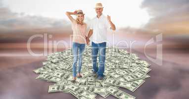 Couple holding hands while walking on money
