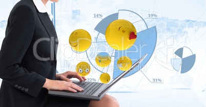 Digital composite image of emojis flying by businesswoman using laptop against tech graphics in back