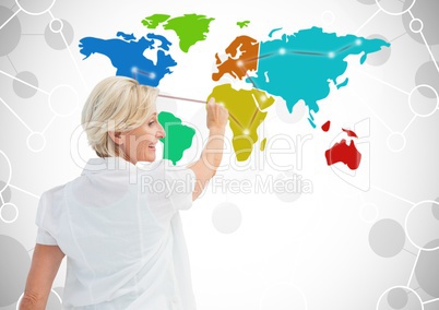 Older Woman drawing on Colorful Map with connected background