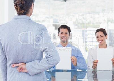 woman with fingers crossed in a interview