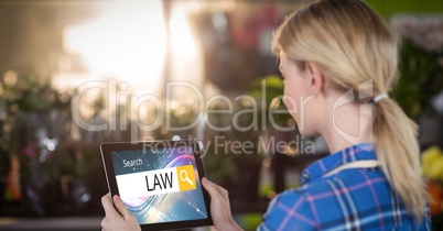 Female student searching for law studies on tablet PC