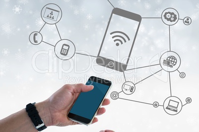 Digital composite image of hand holding smart phone with connection graphics in background
