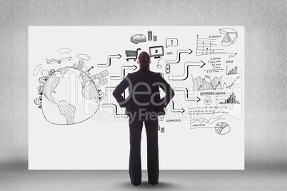 Rear view of business person looking at icons and text on bill board