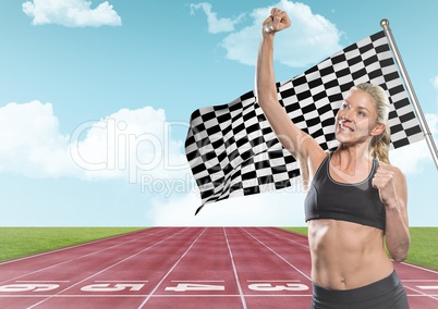 Female runner with hand in air on track against sky and checkered flag