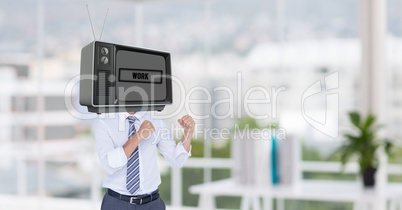 Businessman with TV on head standing in fighting posture