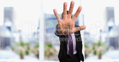 Businessman showing stop gesture in city