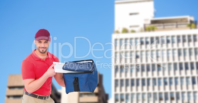 Delivery man removing pizza from bag in city