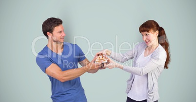 Man and woman fighting for house model