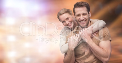 Portrait of happy couple over blurred background