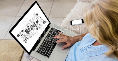High angle view of woman using laptop with blog text on screen while sitting on sofa