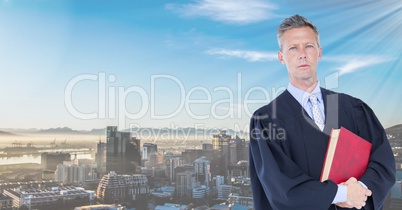 Judge holding book in front of city