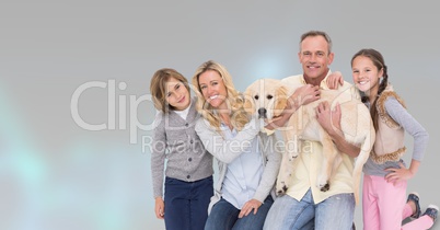 Portrait of happy family with dog against gray background